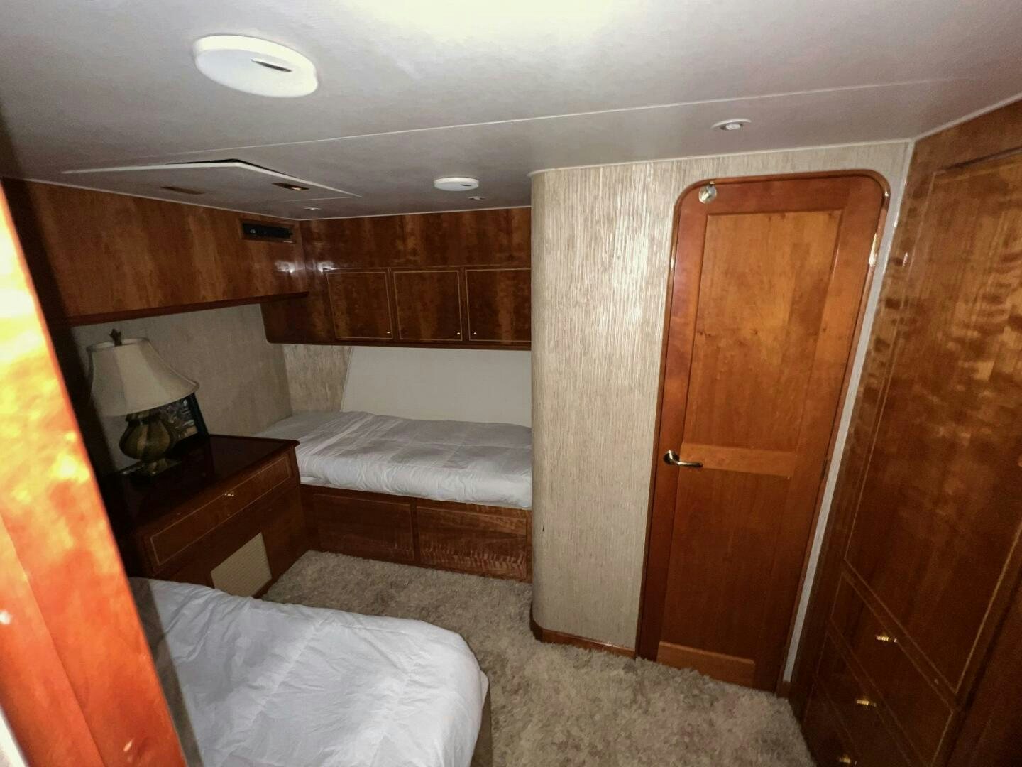 a bedroom with a closet and a bed aboard BUCK-N-BILLS Yacht for Sale