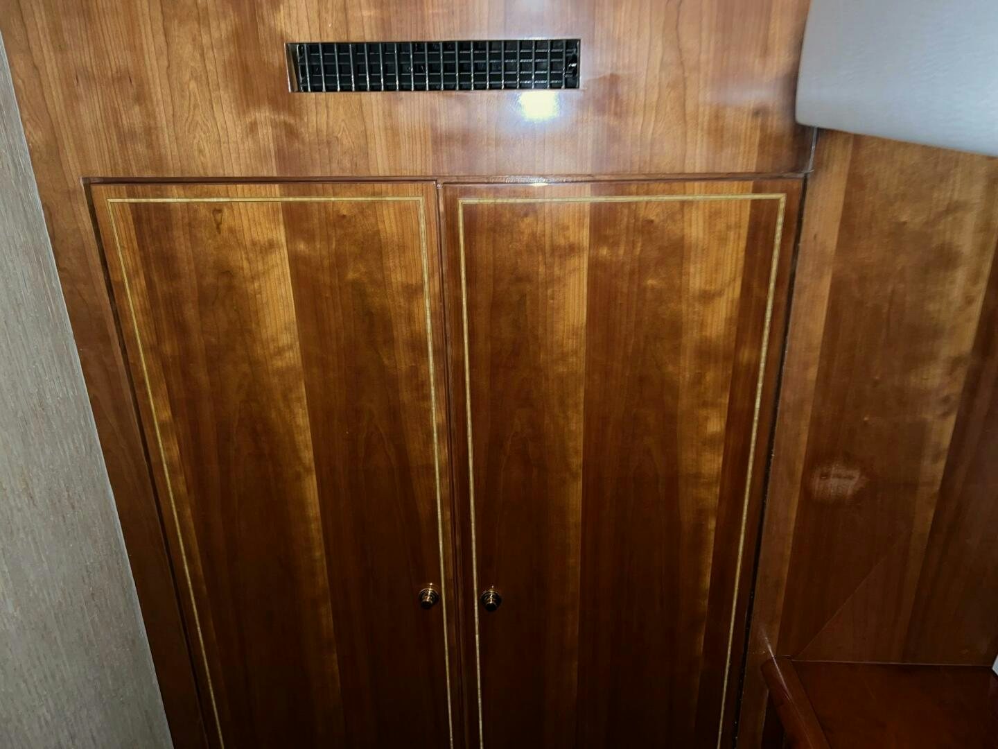 a wooden cabinet with a door aboard BUCK-N-BILLS Yacht for Sale