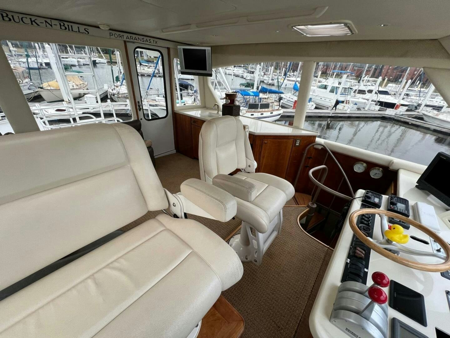 a room with a couch and a table with chairs aboard BUCK-N-BILLS Yacht for Sale