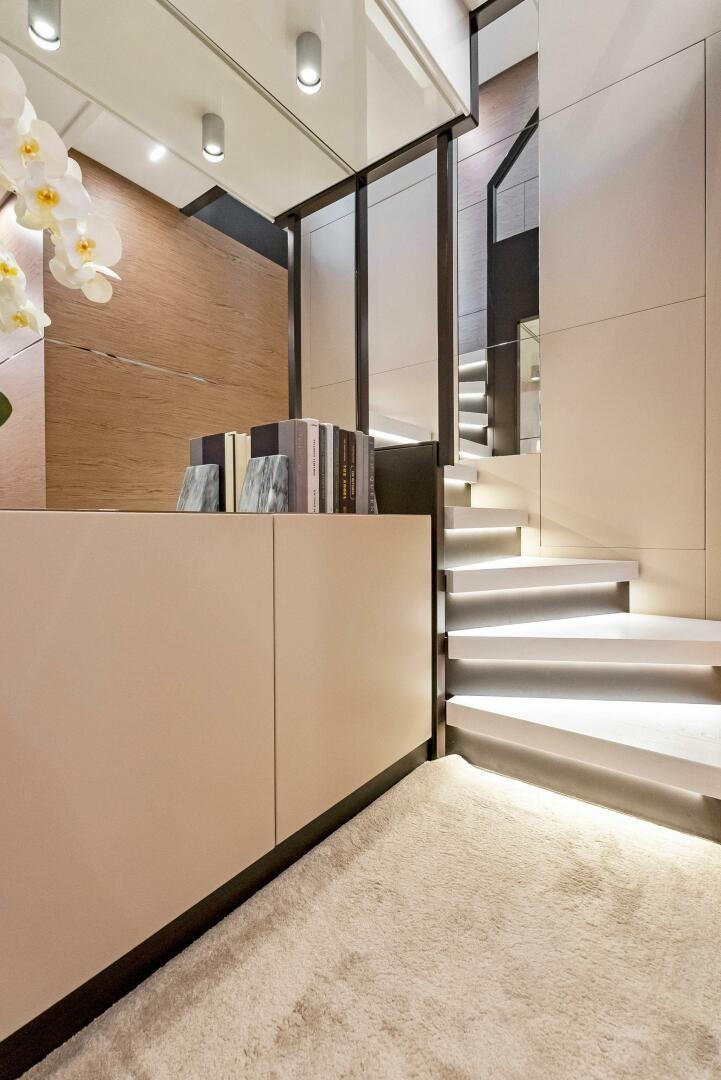 a room with a staircase and a large wood cabinet aboard SILHOUETTE Yacht for Sale