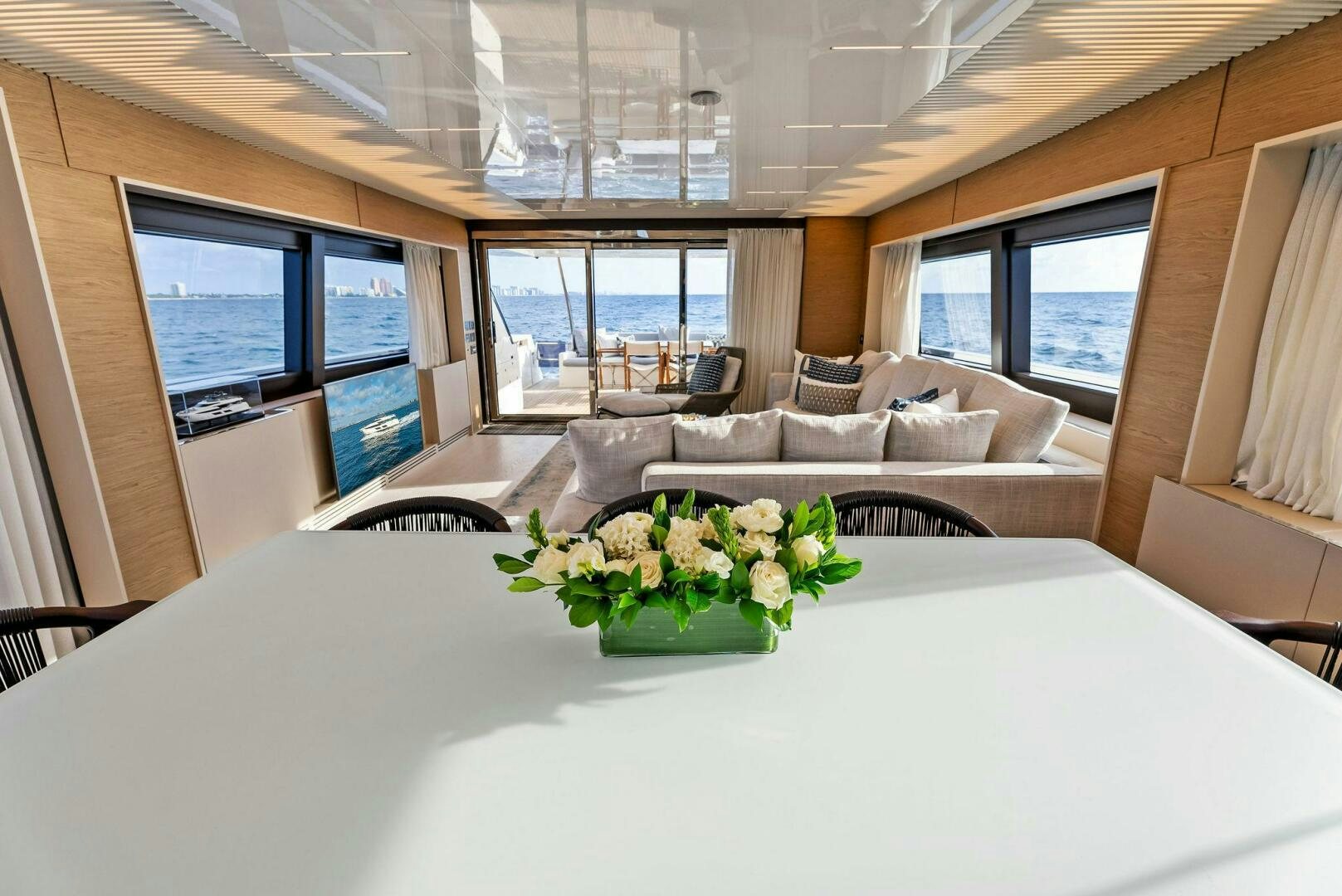 a large white table with flowers on it aboard SILHOUETTE Yacht for Sale