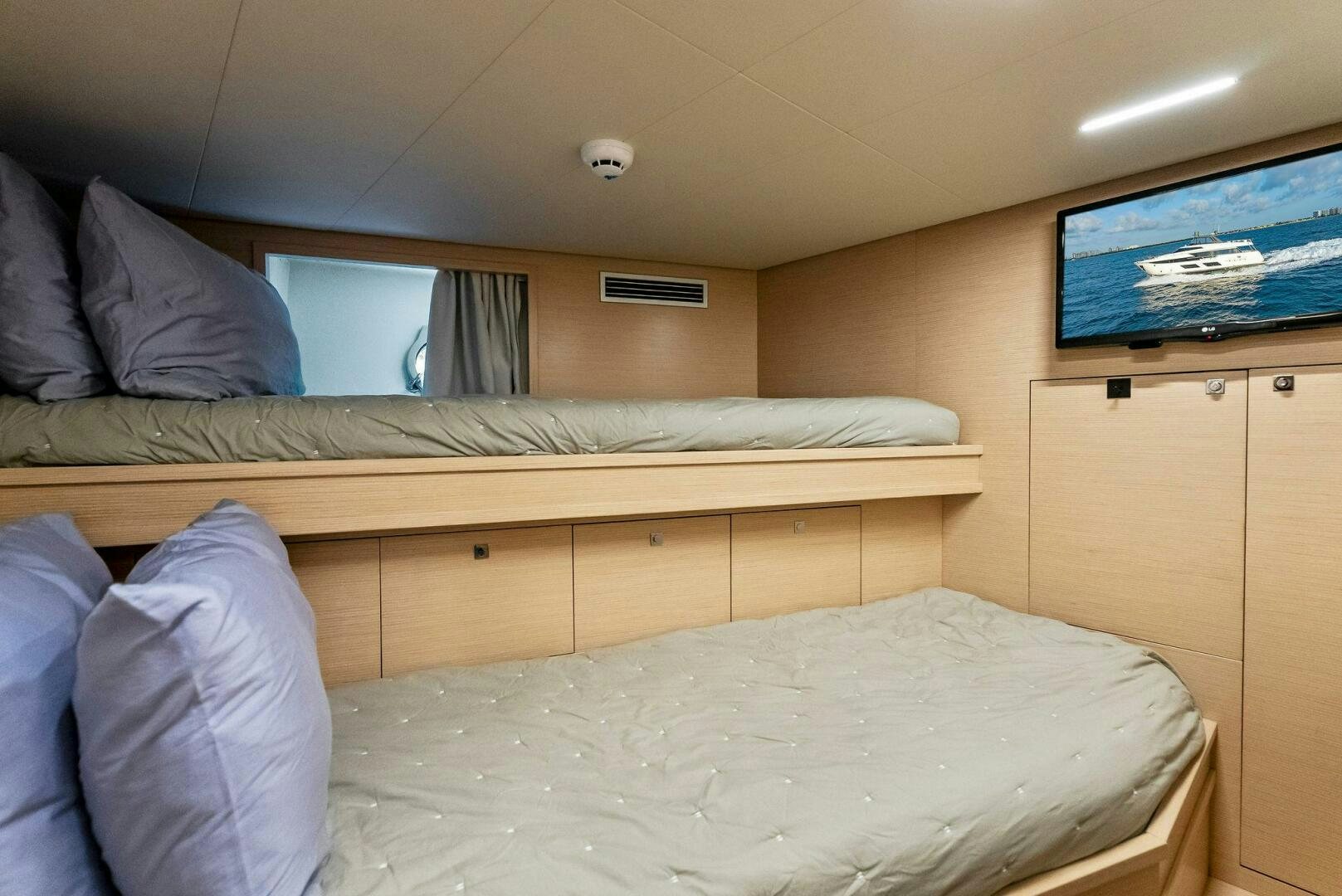 a bed with a television on the wall aboard SILHOUETTE Yacht for Sale