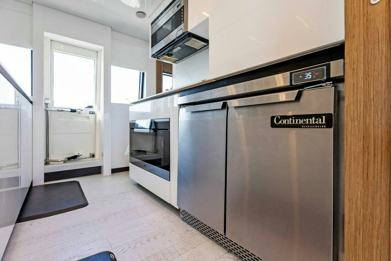 a kitchen with a large refrigerator aboard SILHOUETTE Yacht for Sale