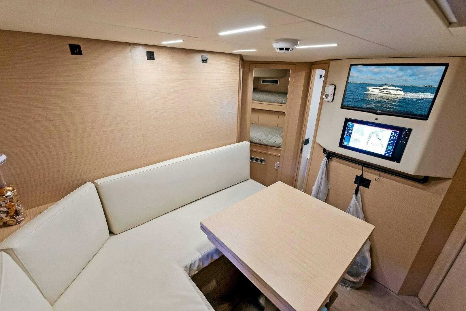 a room with a couch and a tv on the wall aboard SILHOUETTE Yacht for Sale