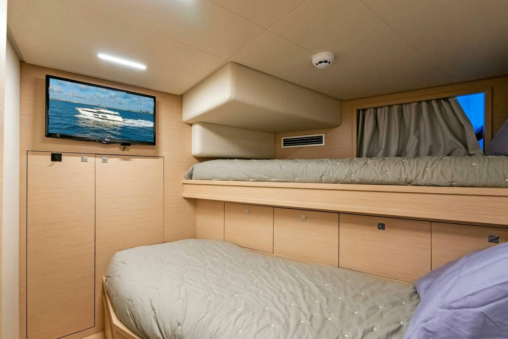 a room with a bed and a tv on the wall aboard SILHOUETTE Yacht for Sale