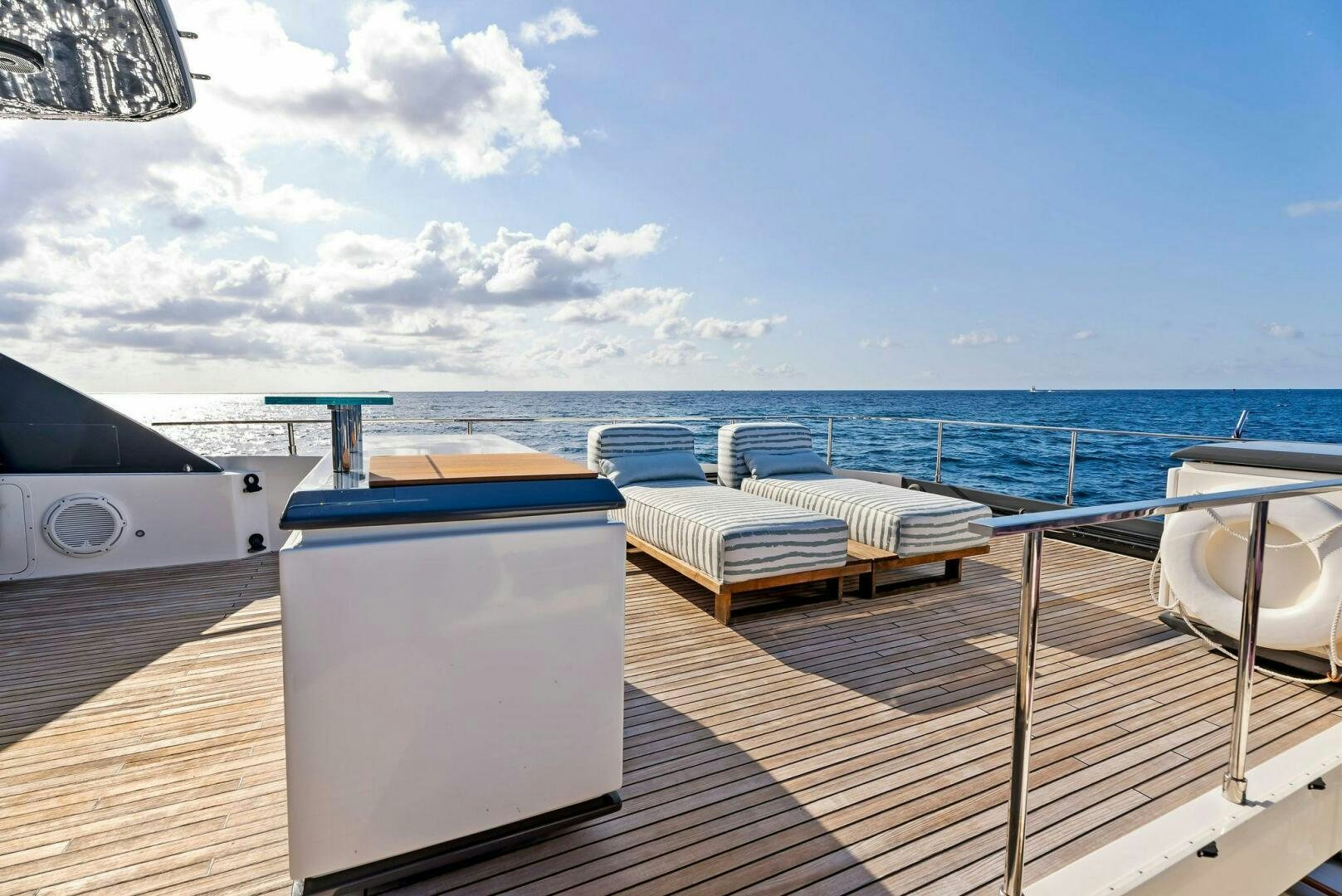 a deck with a view of the ocean and a boat on it aboard SILHOUETTE Yacht for Sale