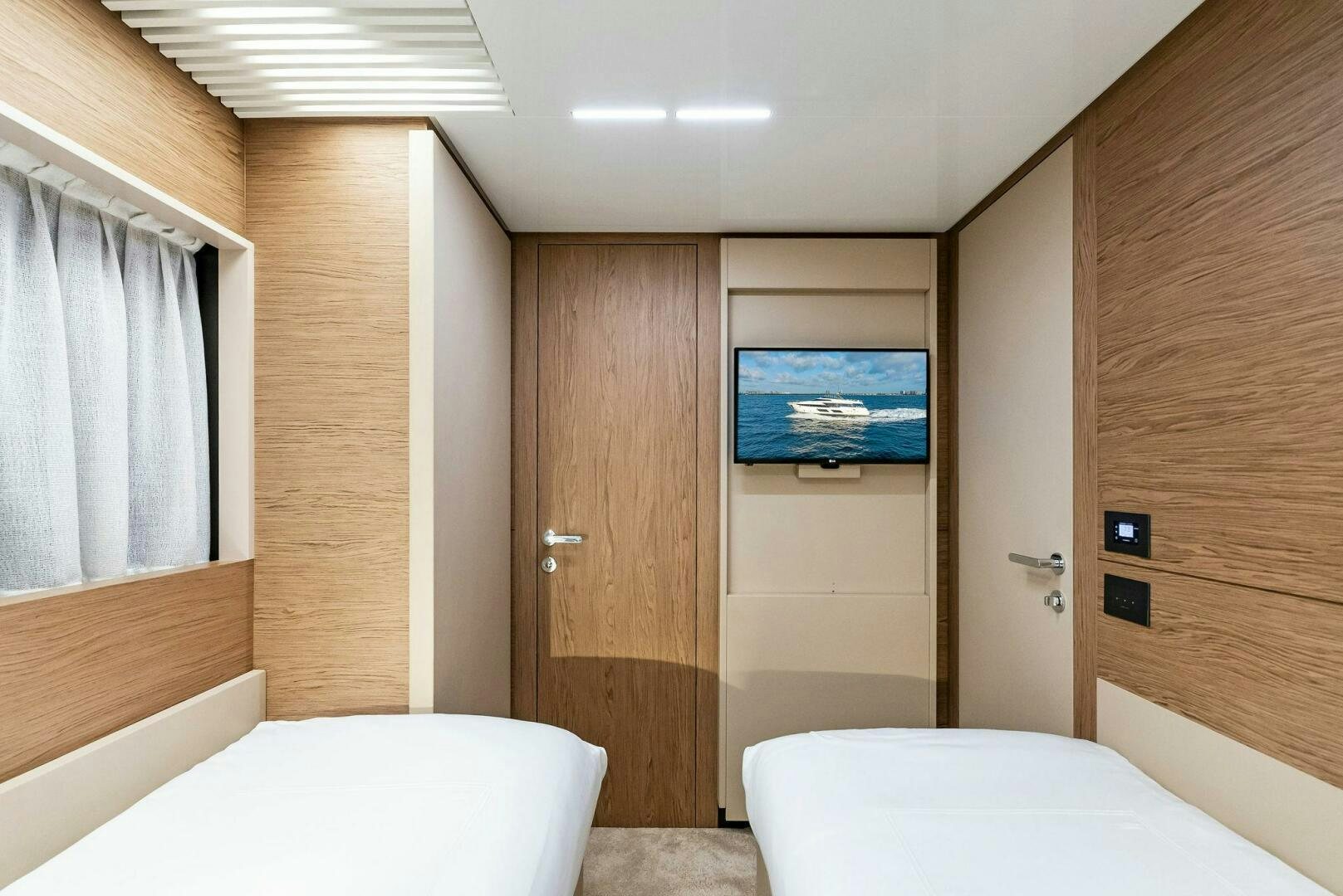 a room with a bed and a television aboard SILHOUETTE Yacht for Sale