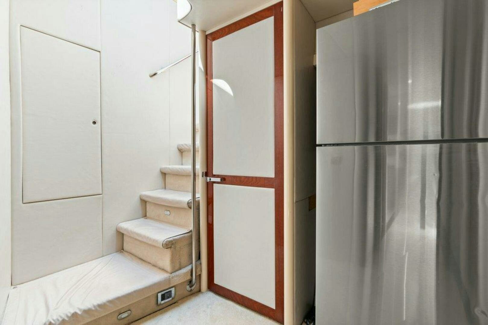 a room with a bed and a closet aboard FOMO2 Yacht for Sale