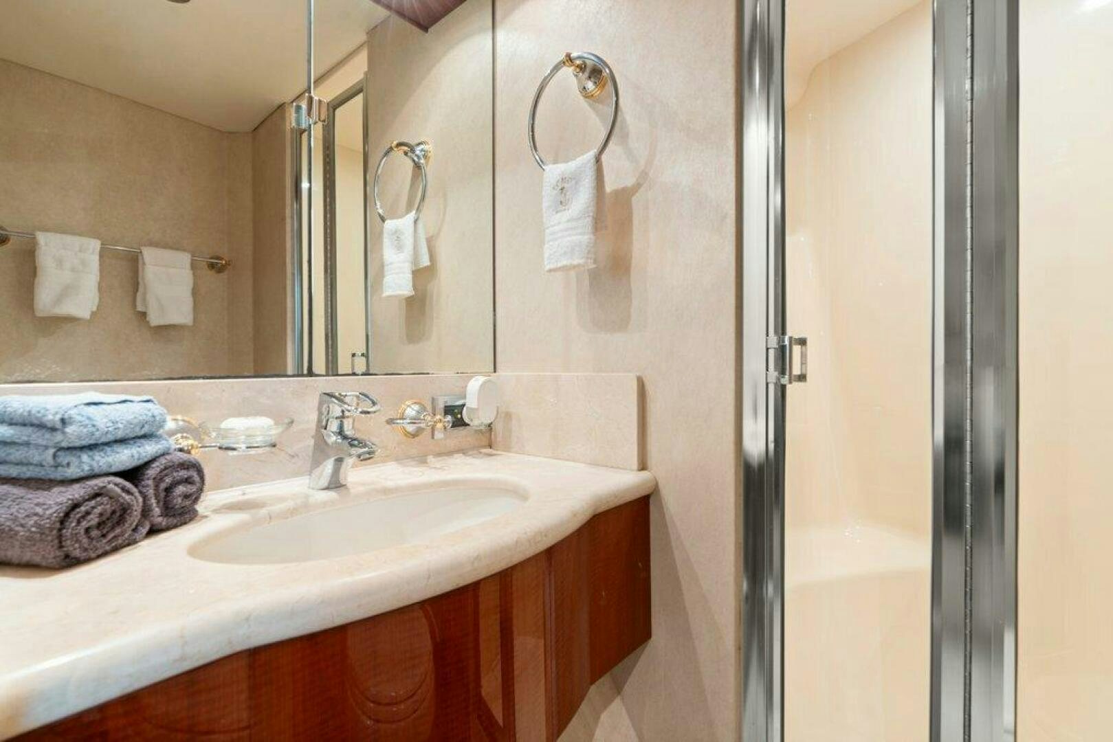 a bathroom with a sink and mirror aboard FOMO2 Yacht for Sale