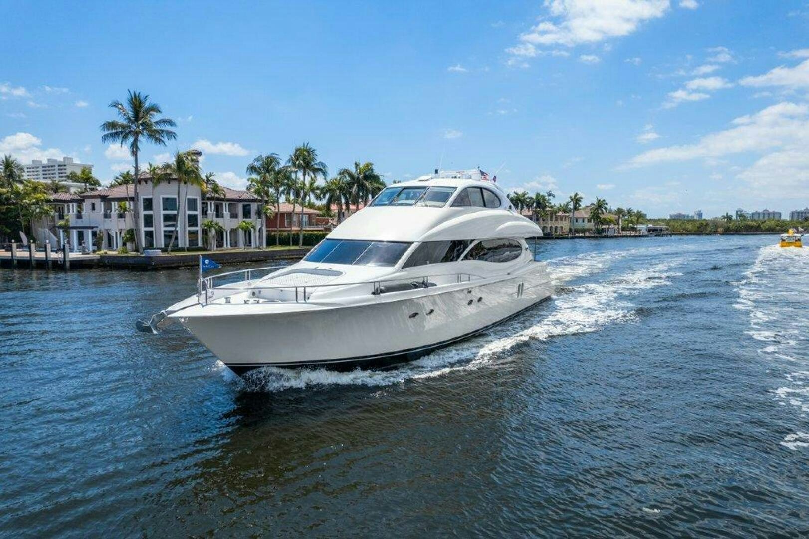 a white boat on the water aboard FOMO2 Yacht for Sale