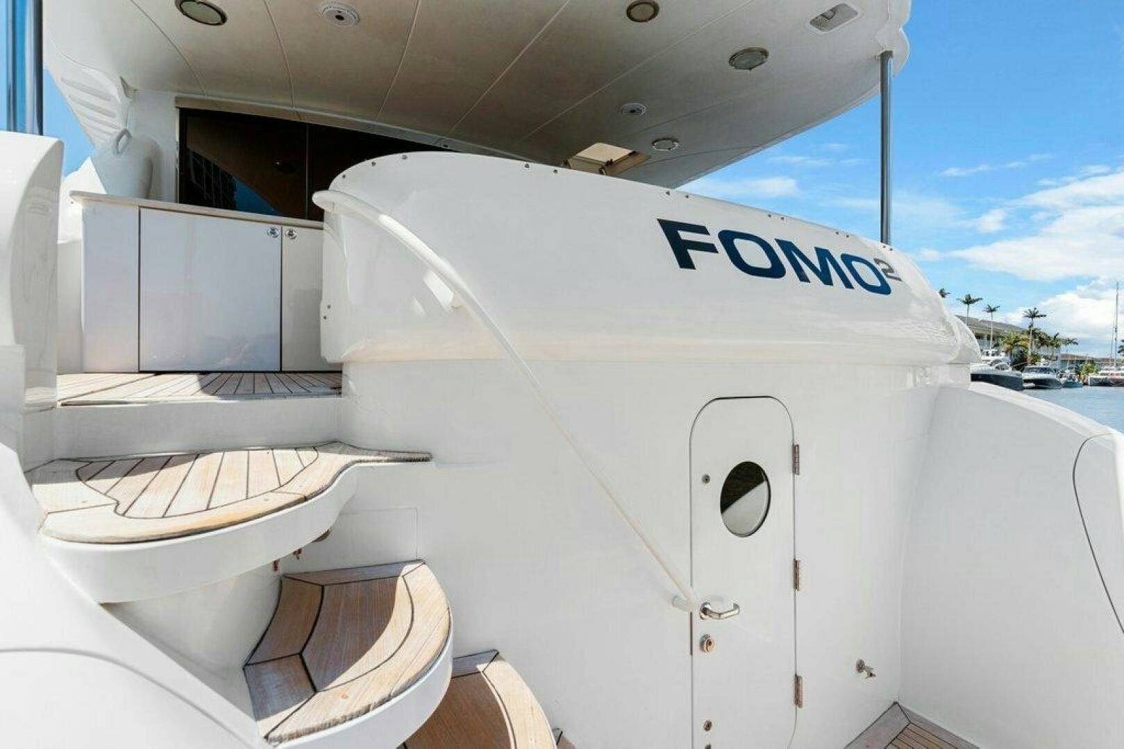 a white boat with a door aboard FOMO2 Yacht for Sale