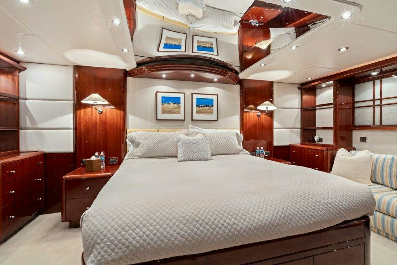 a room with a bed and a mirror aboard FOMO2 Yacht for Sale
