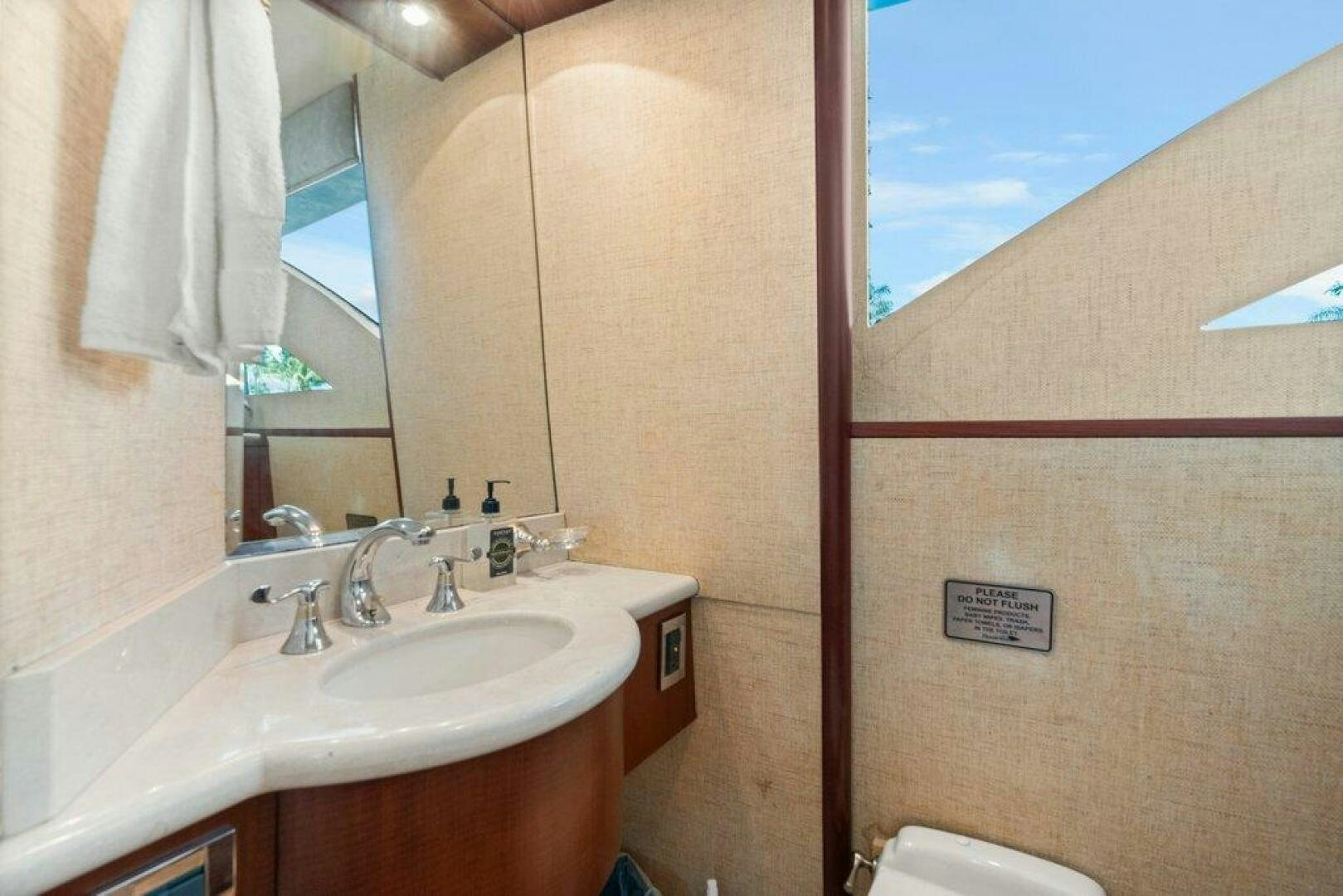 a bathroom with a sink and a mirror aboard FOMO2 Yacht for Sale