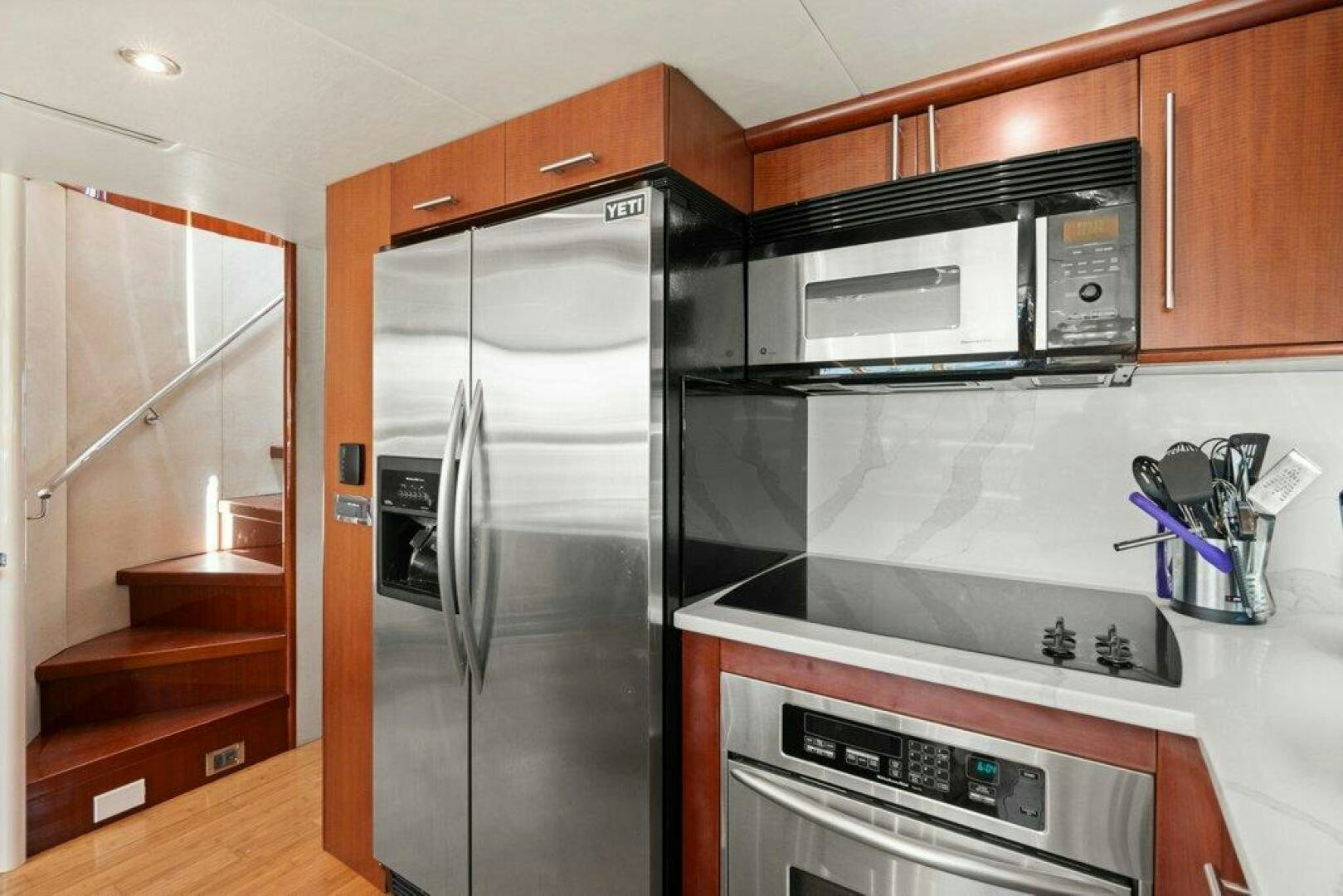 a kitchen with stainless steel appliances aboard FOMO2 Yacht for Sale