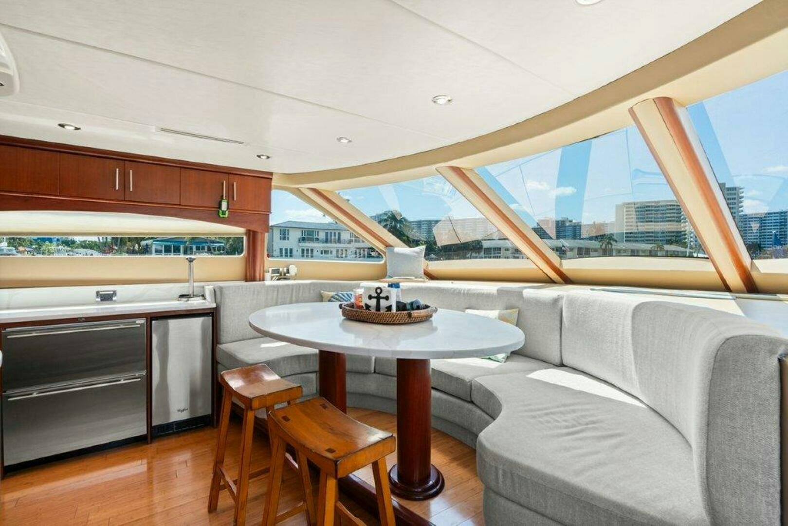 a living room with a table and couches aboard FOMO2 Yacht for Sale