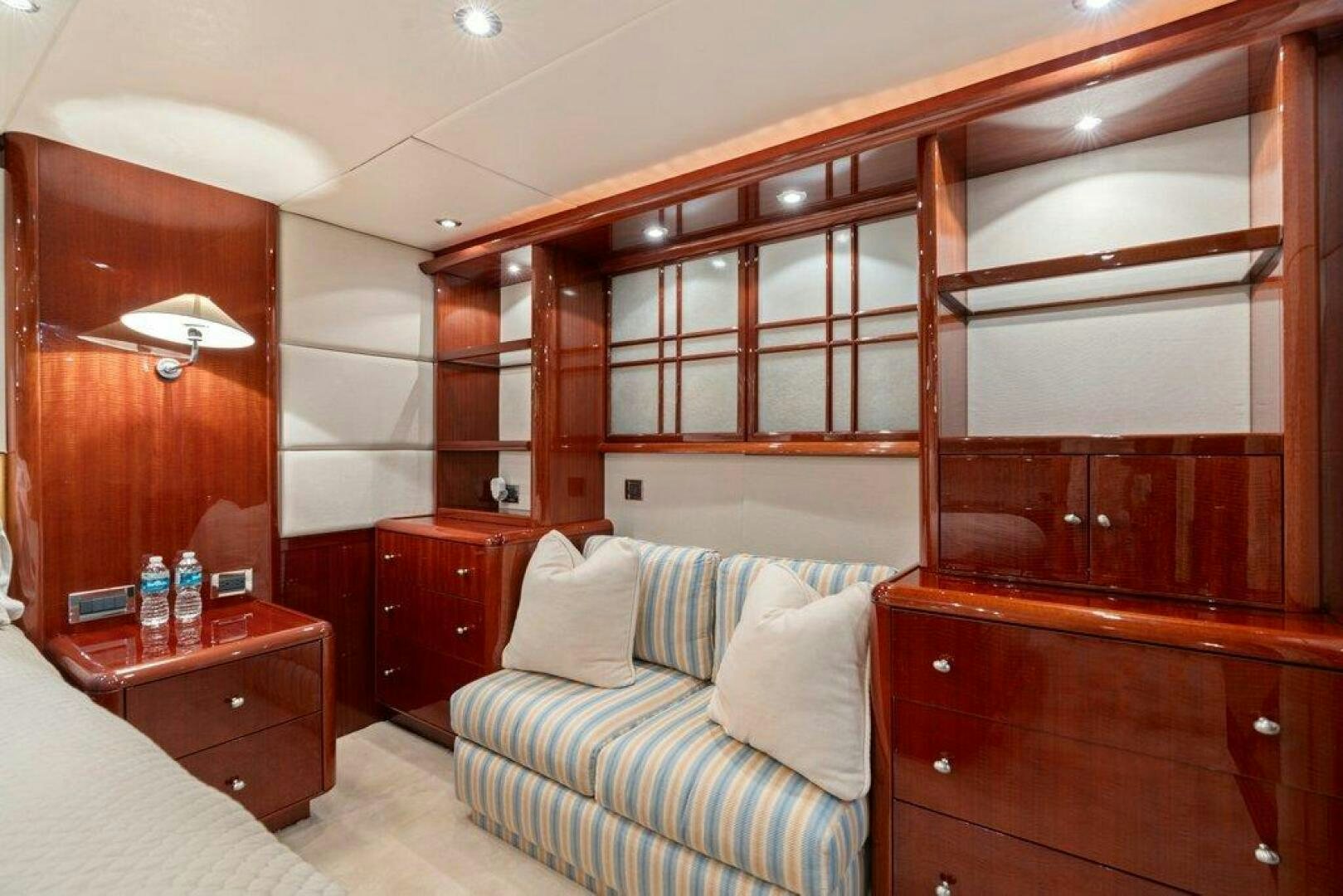 a room with a bed and a dresser aboard FOMO2 Yacht for Sale