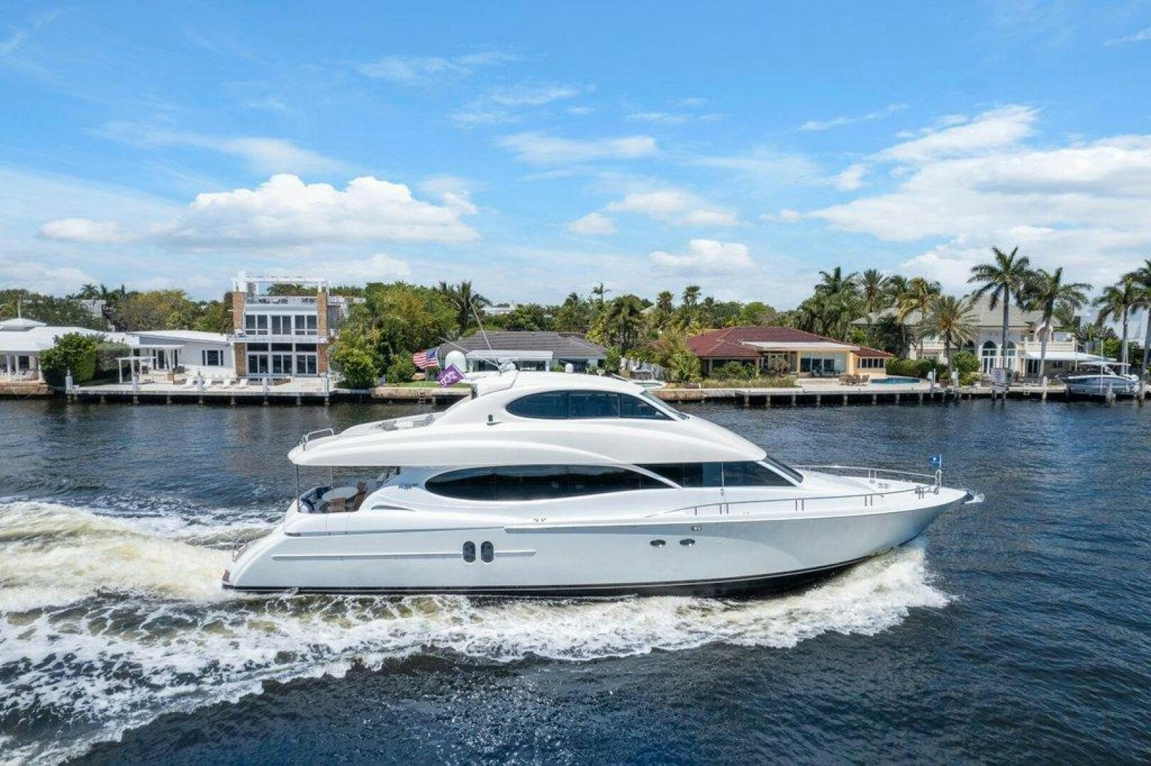 a white boat on the water aboard FOMO2 Yacht for Sale