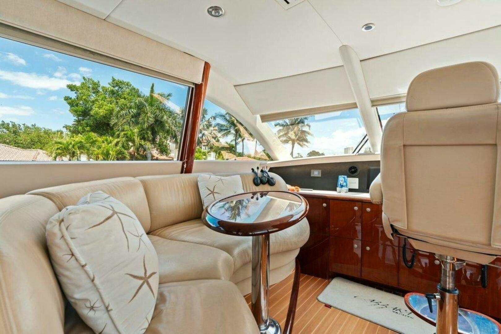 a room with a couch and a table and a window aboard FOMO2 Yacht for Sale