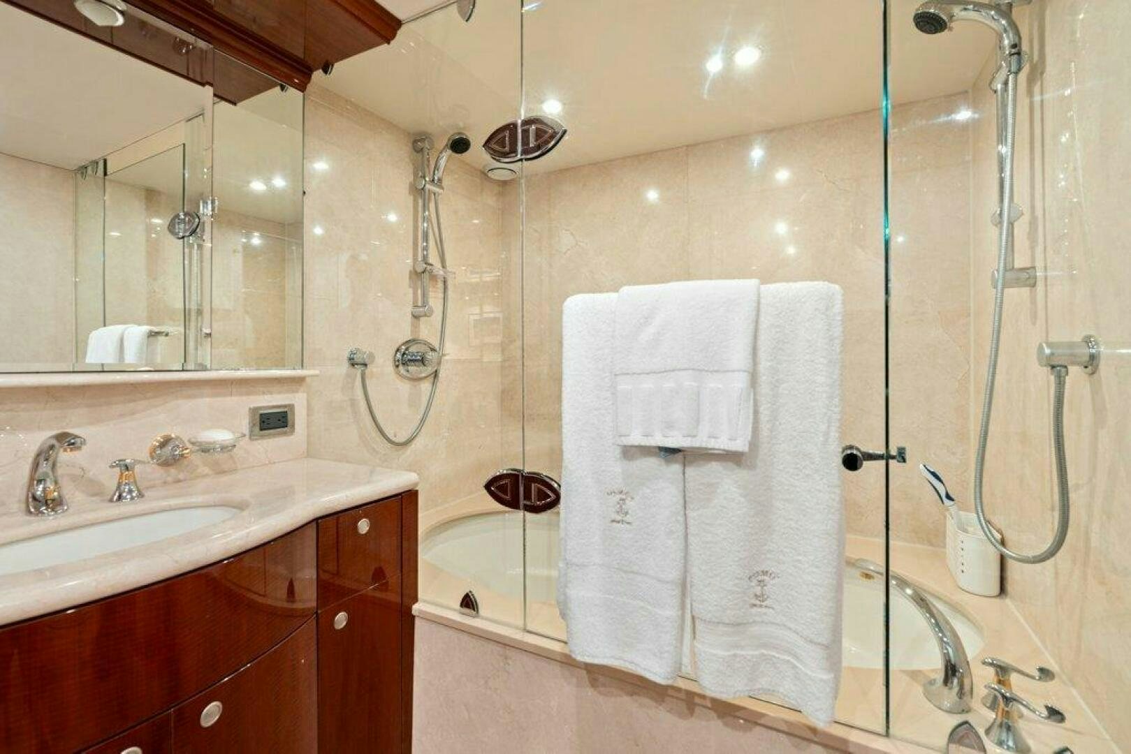 a bathroom with a bathtub and sink aboard FOMO2 Yacht for Sale