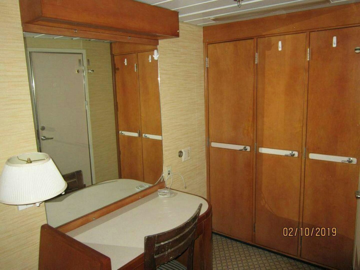 a bathroom with a large wooden closet aboard AMERICANA Yacht for Sale