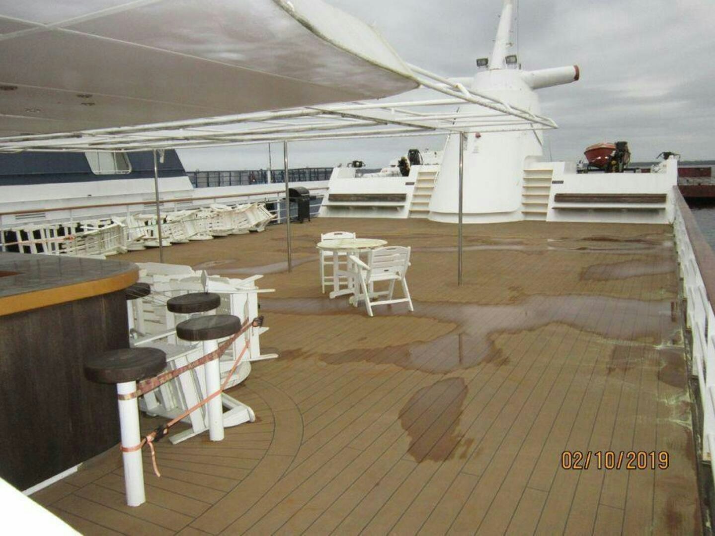 a deck with chairs and a plane aboard AMERICANA Yacht for Sale