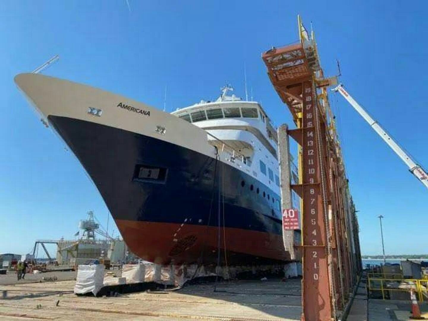 a large white ship docked aboard AMERICANA Yacht for Sale