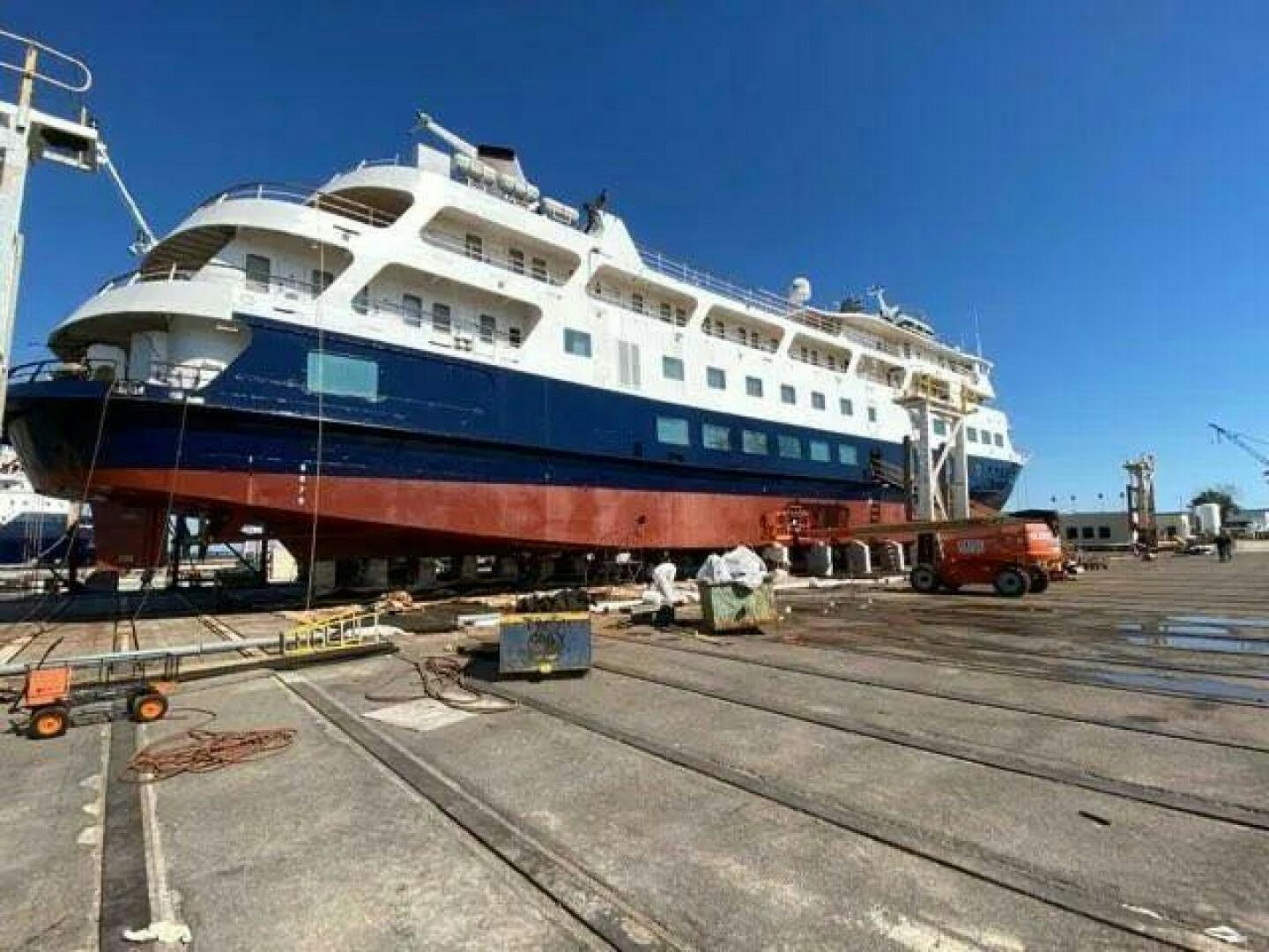 a large cruise ship docked aboard AMERICANA Yacht for Sale