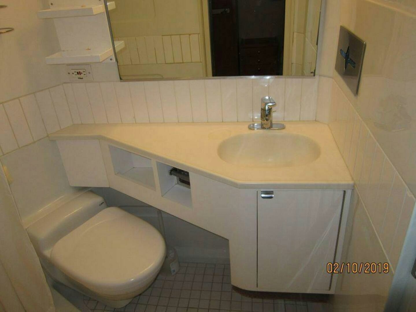 a bathroom with a toilet and sink aboard AMERICANA Yacht for Sale