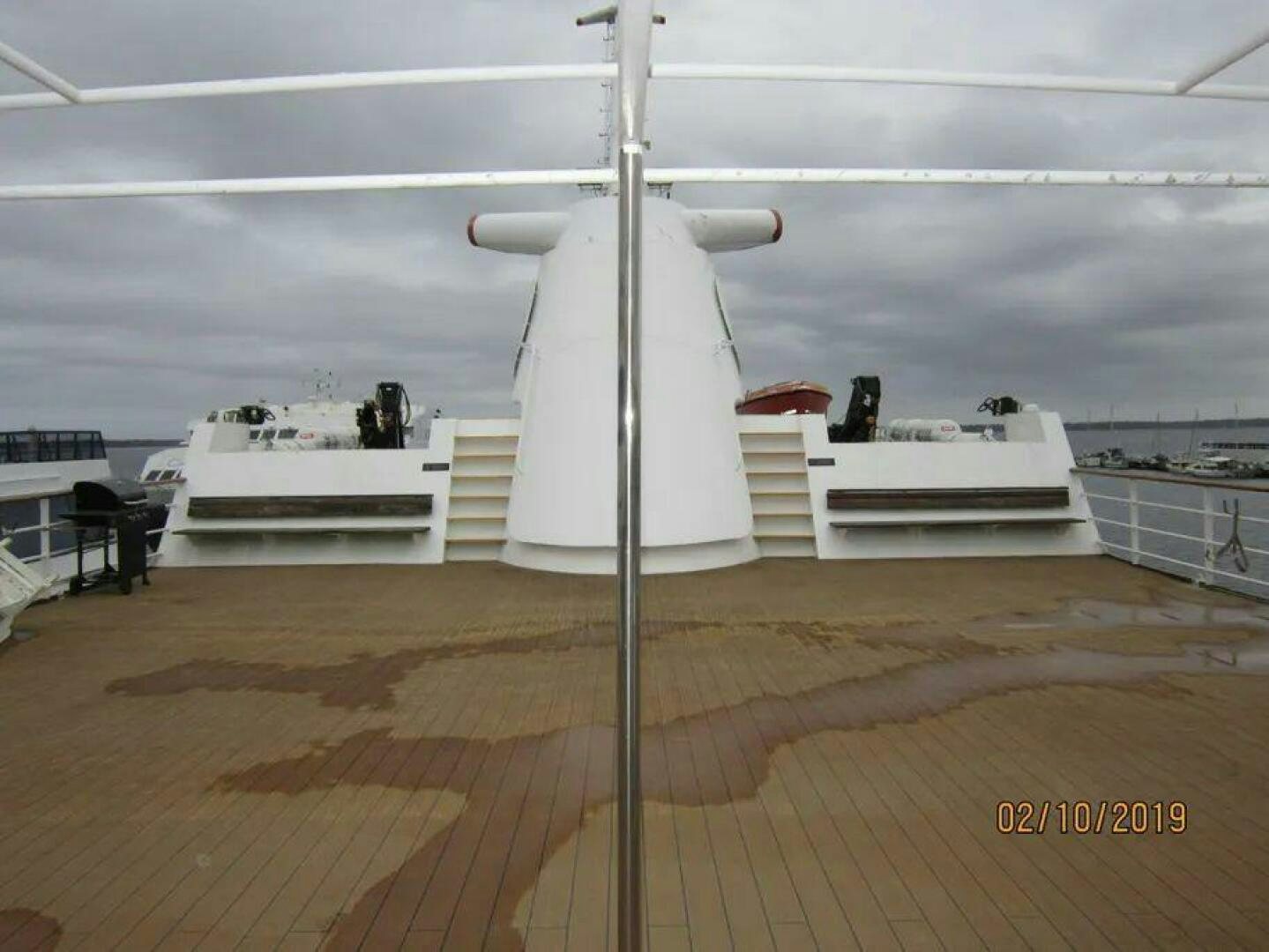 a white cylindrical object on a wooden surface aboard AMERICANA Yacht for Sale