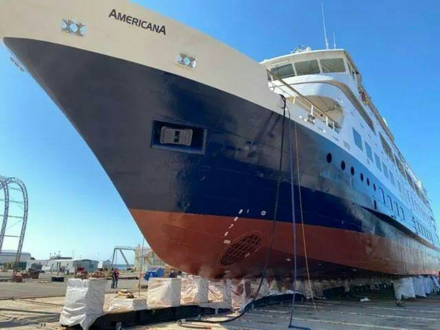 a large ship docked aboard AMERICANA Yacht for Sale