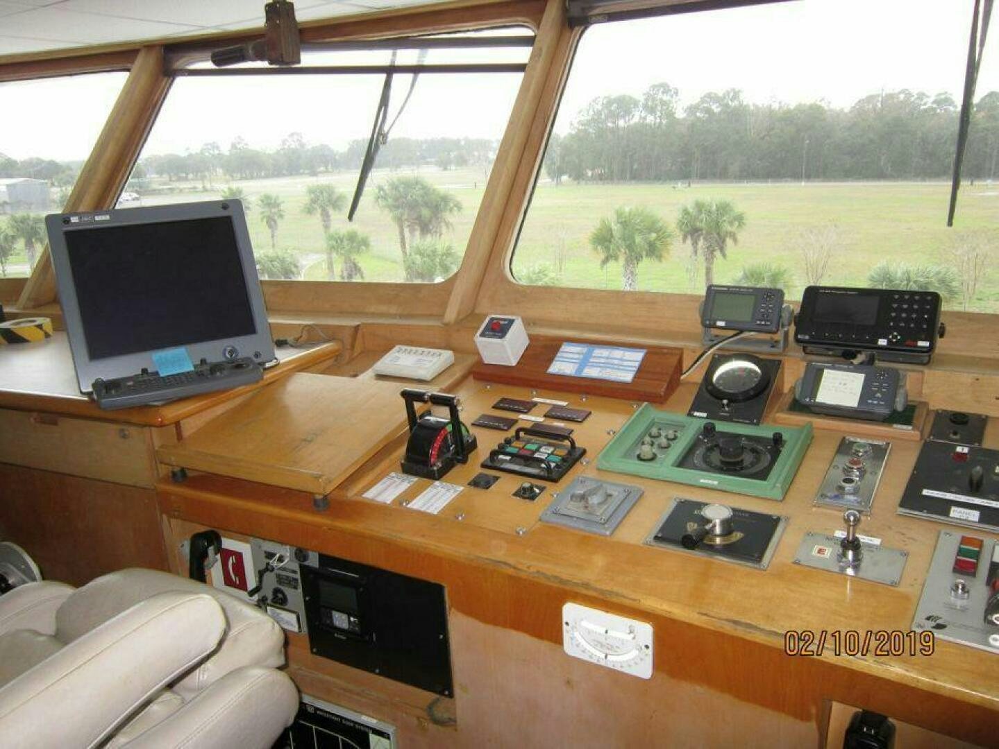 a table with a laptop and other electronics on it aboard AMERICANA Yacht for Sale