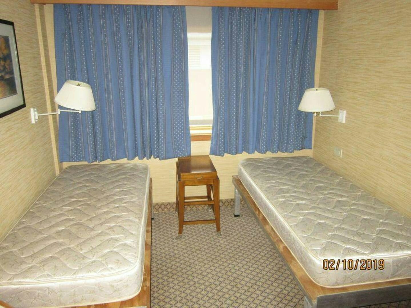 a room with two beds aboard AMERICANA Yacht for Sale