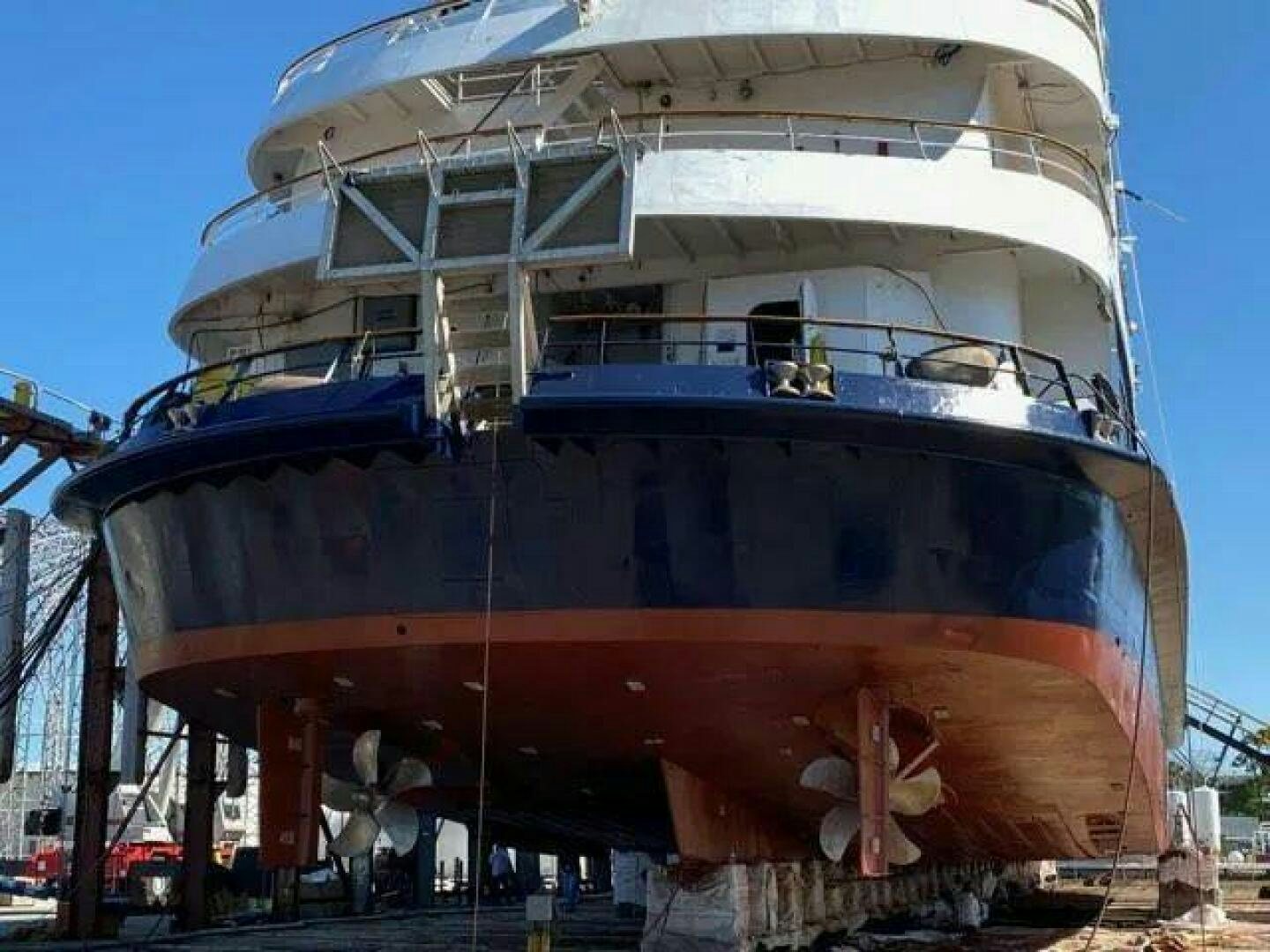a large ship with a blue and red design aboard AMERICANA Yacht for Sale
