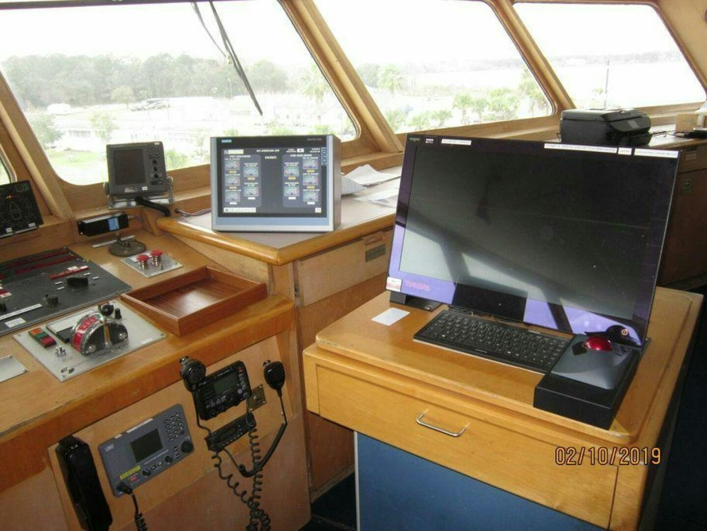 a desk with a computer and other electronics on it aboard AMERICANA Yacht for Sale