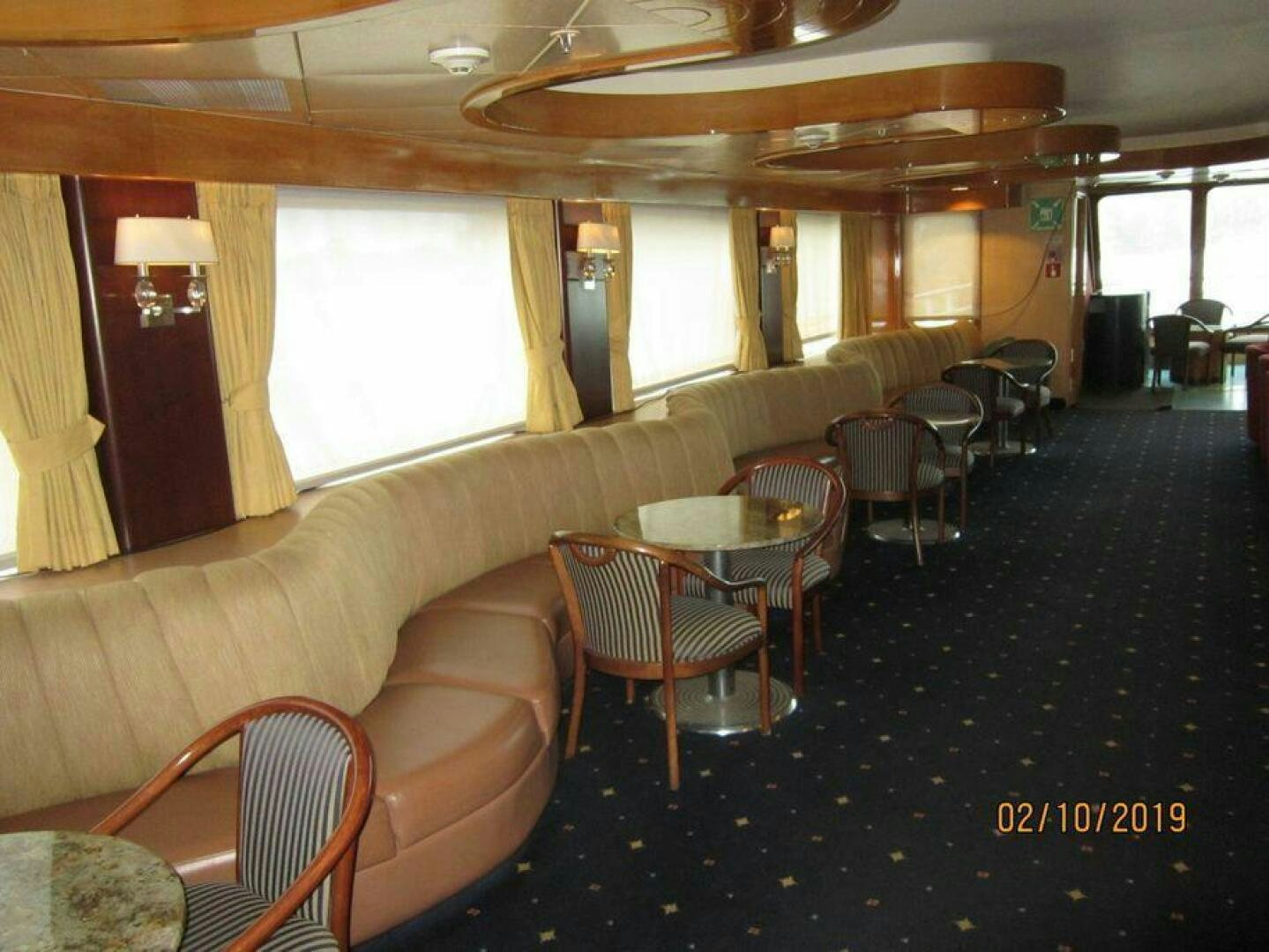a living room with a couch and chairs aboard AMERICANA Yacht for Sale