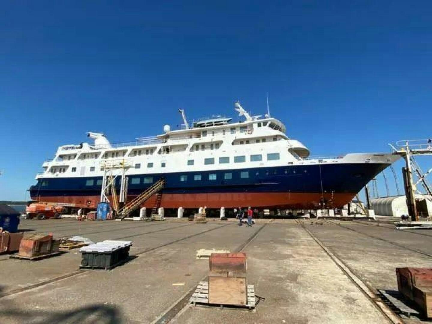 a large cruise ship docked aboard AMERICANA Yacht for Sale