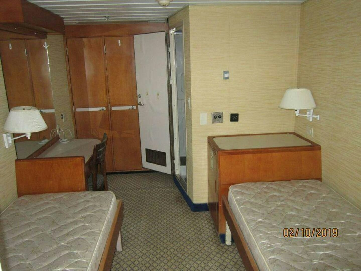 a bedroom with a bed and a desk aboard AMERICANA Yacht for Sale