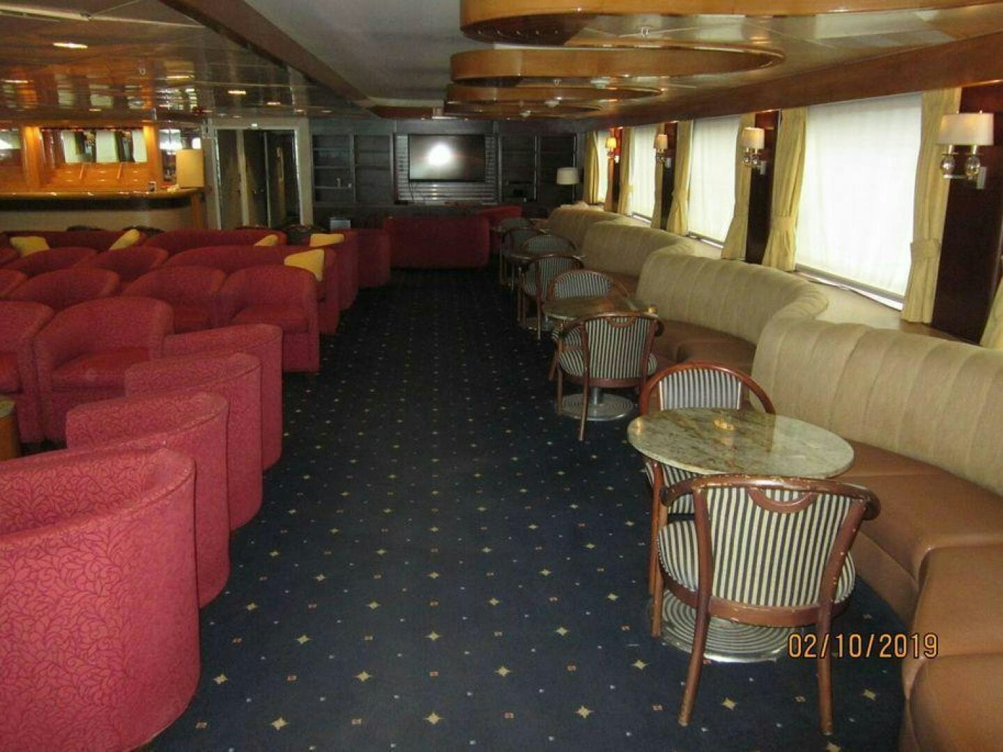 a room with a couch and chairs aboard AMERICANA Yacht for Sale