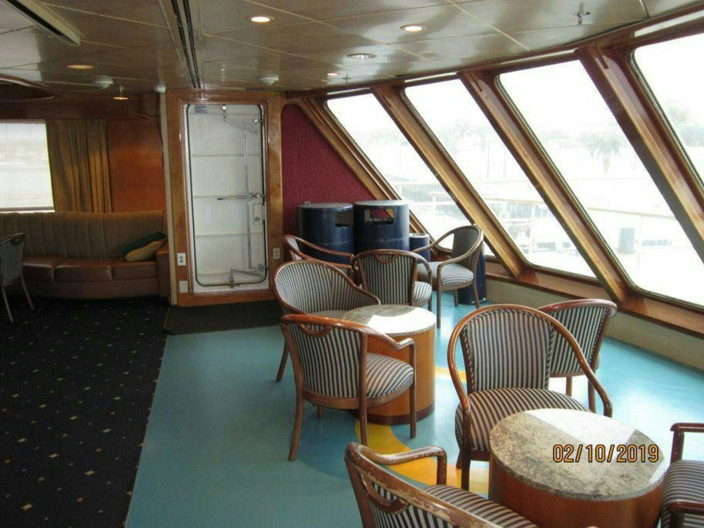 a room with chairs and tables aboard AMERICANA Yacht for Sale