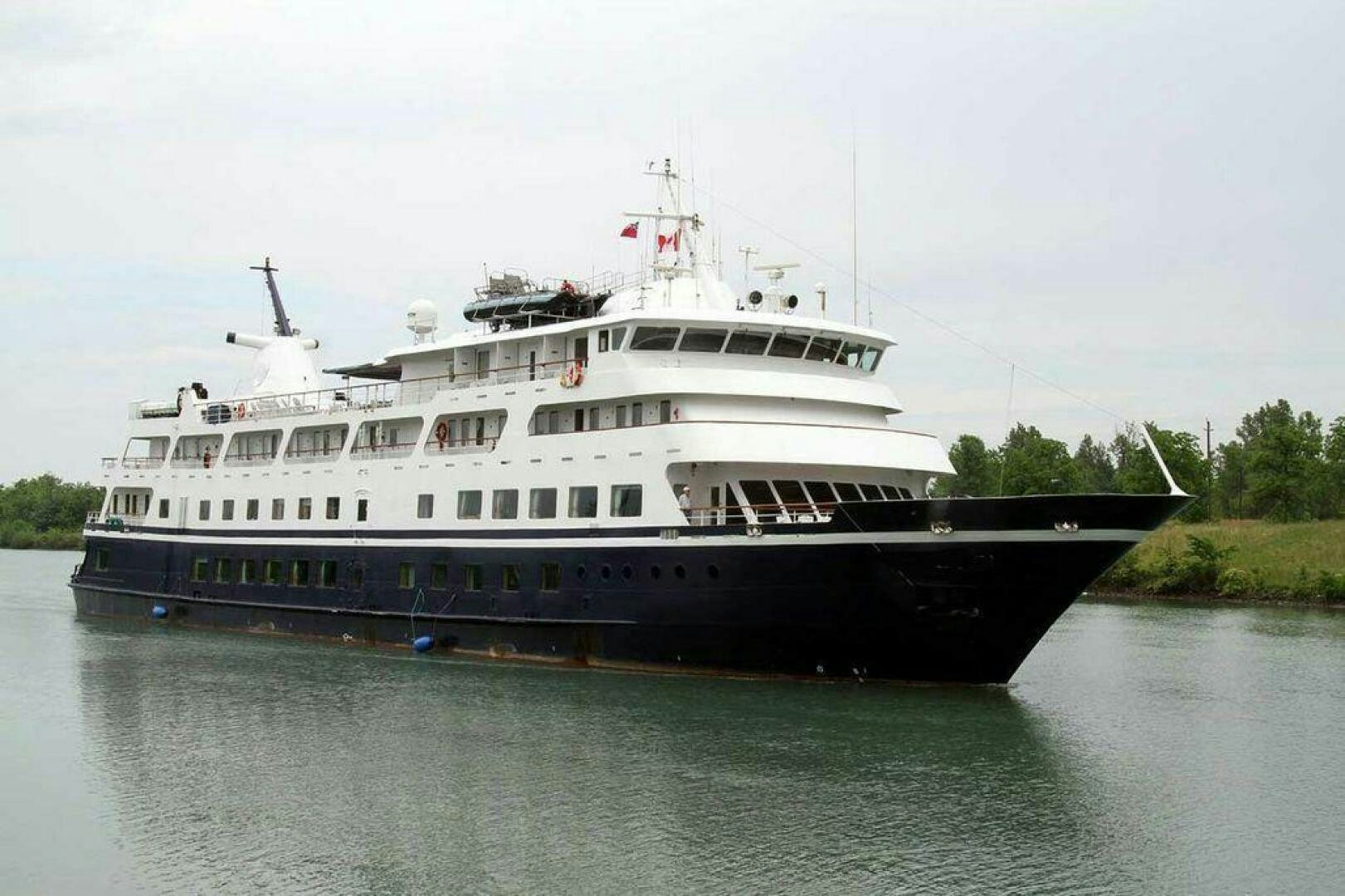 a large boat on the water aboard AMERICANA Yacht for Sale