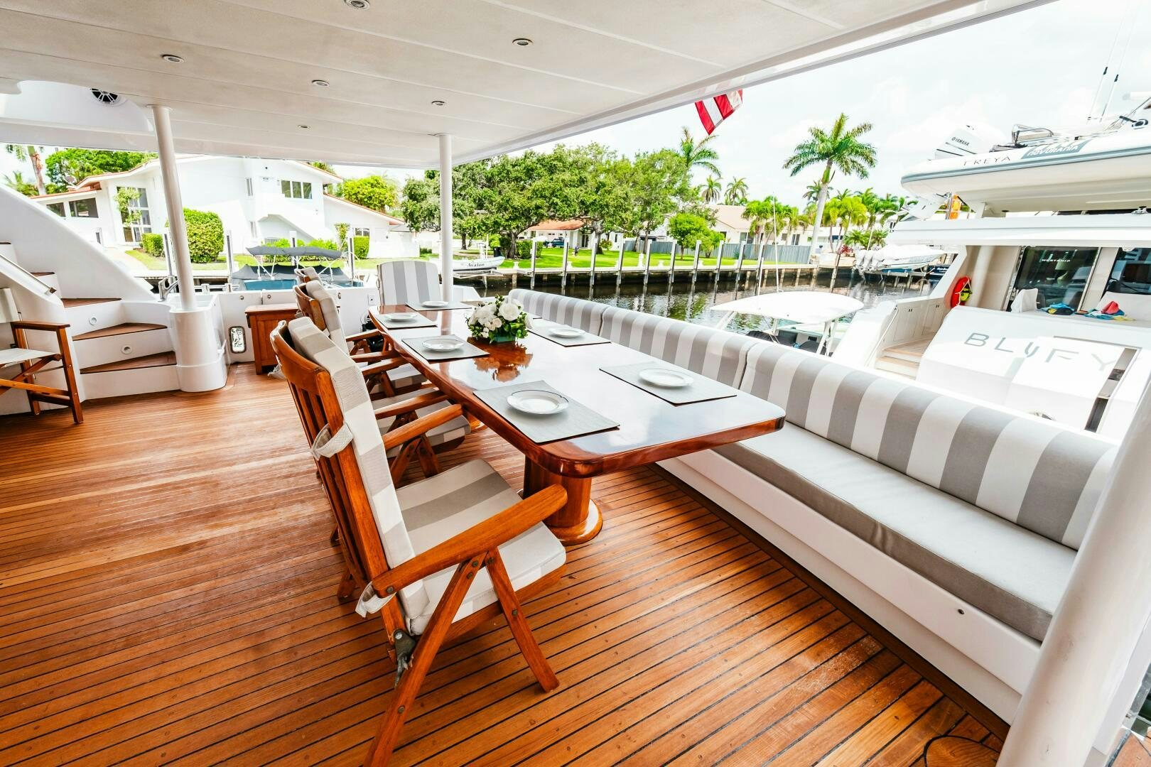 a table and chairs on a patio aboard GLORIAS SUN Yacht for Sale