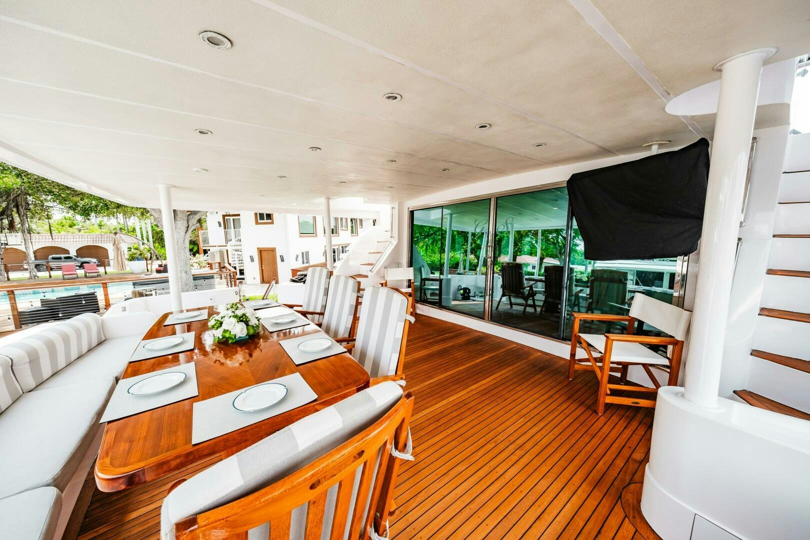 a dining table and chairs in a room with a large window aboard GLORIAS SUN Yacht for Sale