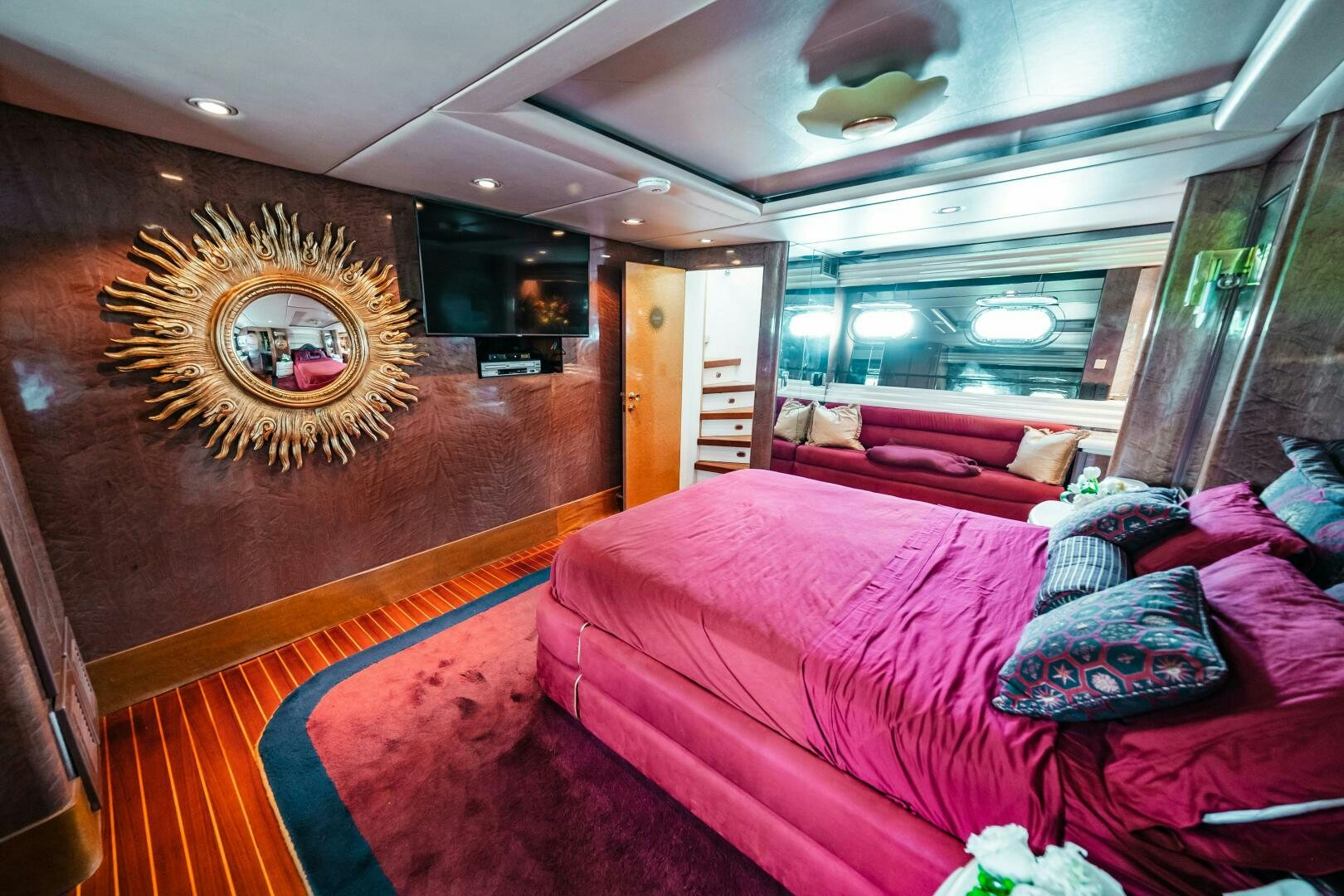 a room with a bed and a painting on the wall aboard GLORIAS SUN Yacht for Sale