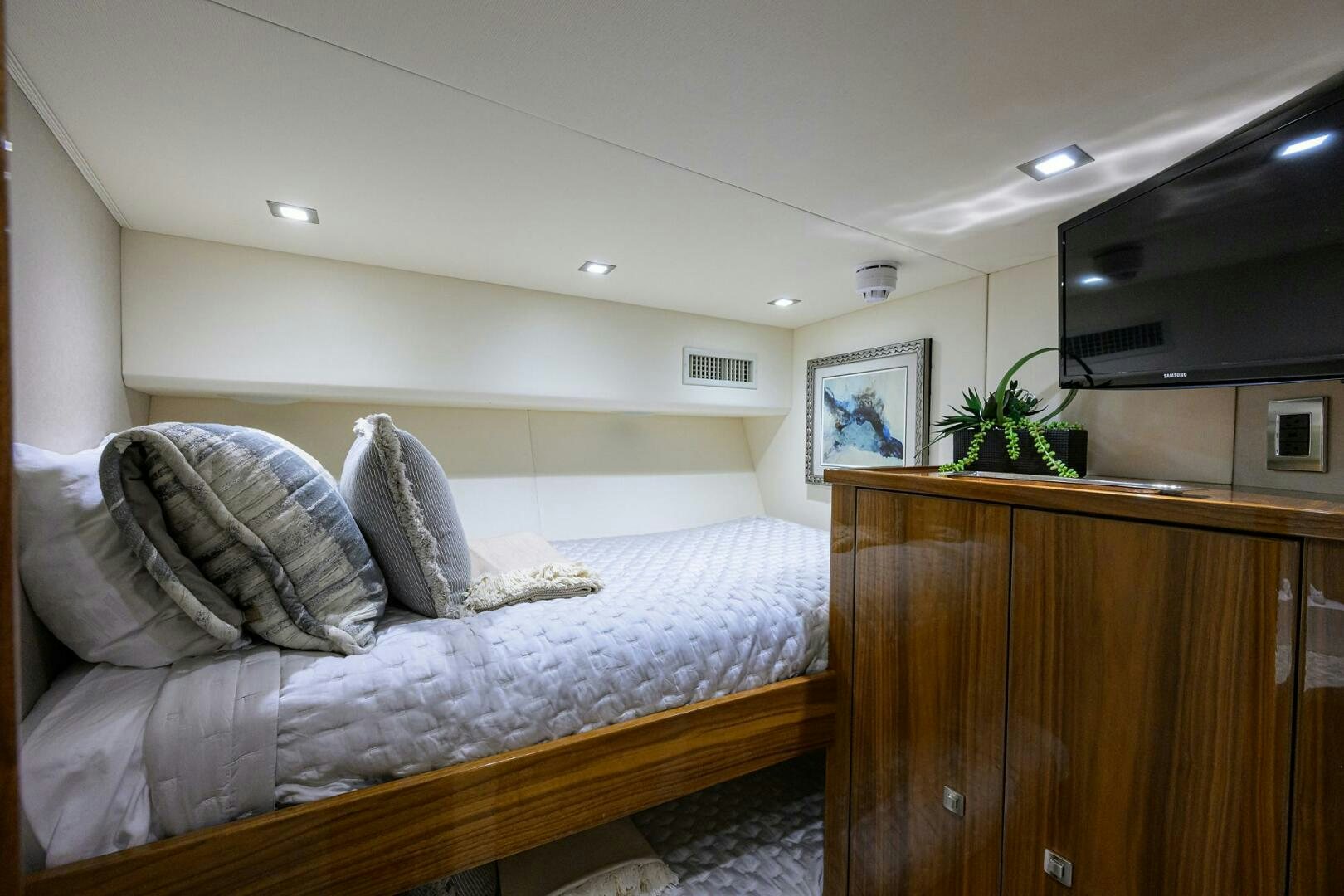 a bedroom with a bed and a television aboard BACCHUS Yacht for Sale