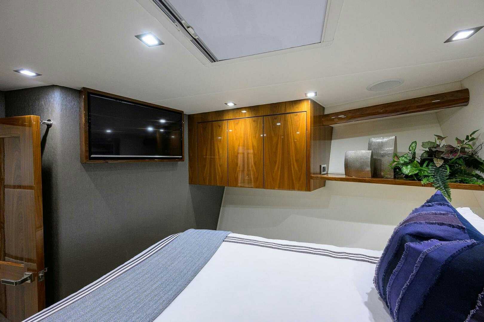 a room with a tv and a bed aboard BACCHUS Yacht for Sale