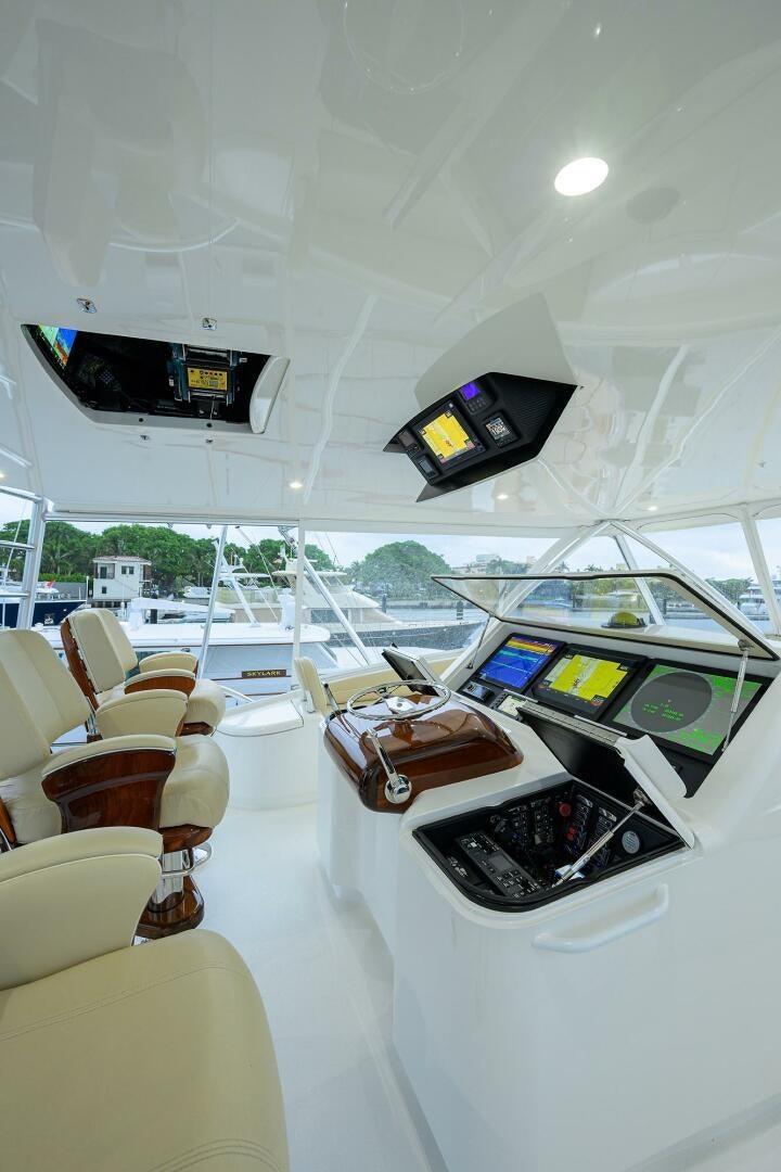 inside of a white tent with a table and chairs and a couple of screens on the wall with aboard BACCHUS Yacht for Sale