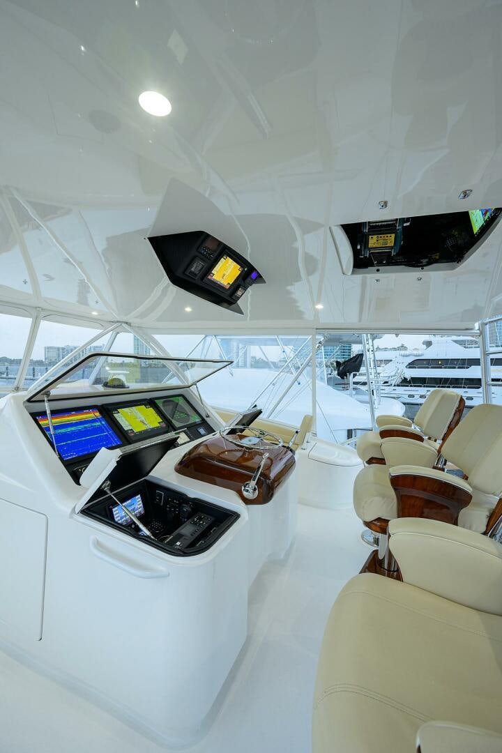 inside of a white room with a table and chairs and a large window aboard BACCHUS Yacht for Sale