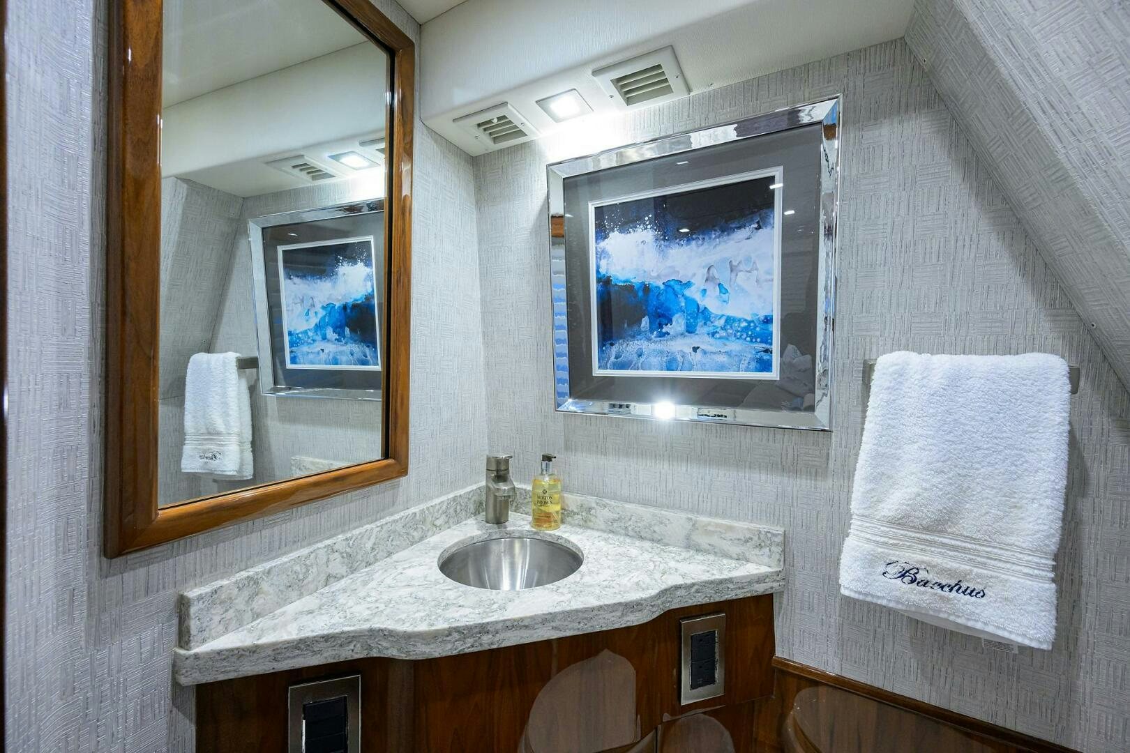 a bathroom with a sink and a mirror aboard BACCHUS Yacht for Sale