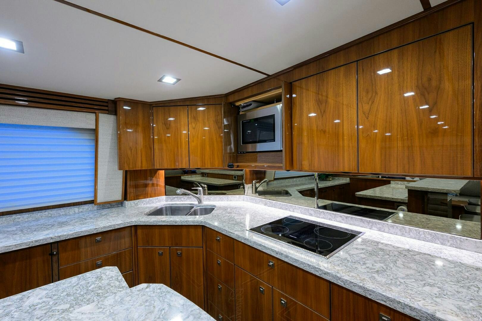 a kitchen with wooden cabinets aboard BACCHUS Yacht for Sale