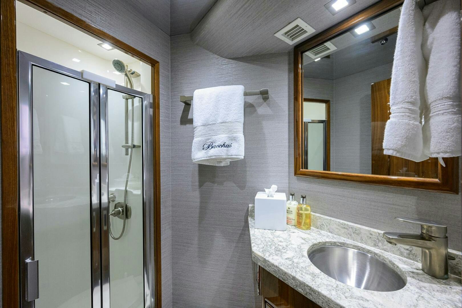 a bathroom with a sink and a shower unit aboard BACCHUS Yacht for Sale